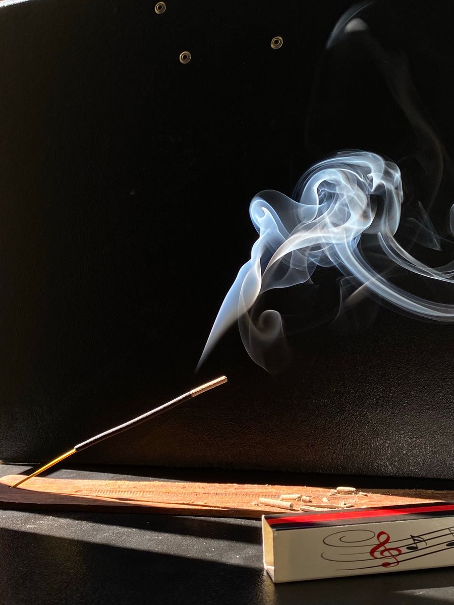 Delicate incense smoke against a dark background